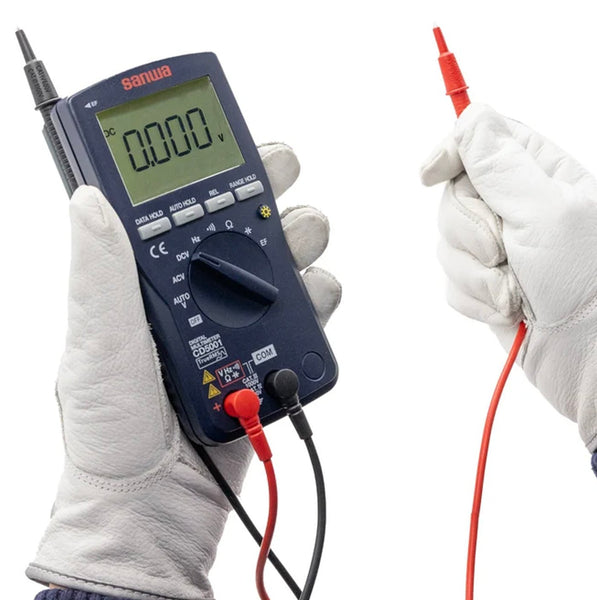 Digital multimeter with True RMS and EF Sensing by Sanwa, held in gloved hands with red and black test leads.
