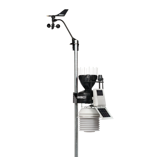 Complete weather station with anemometer by Davis Instruments, mounted on a gray pole with a radiation shield and a solar panel.
