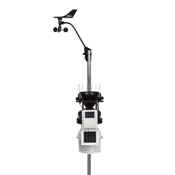 Automatic weather station by Davis Instruments with anemometer and solar panels on a metal pole.