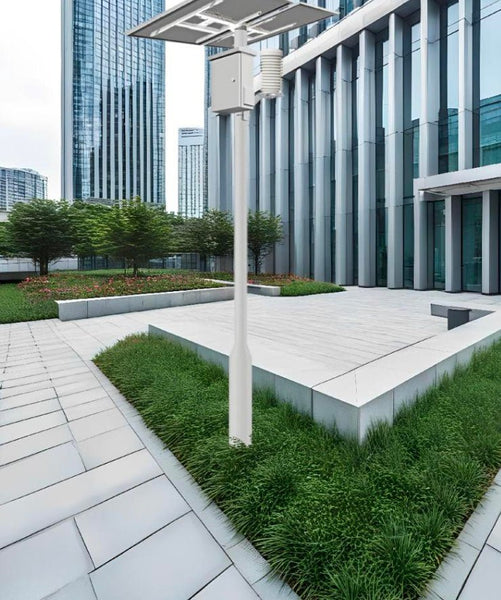 Outdoor air quality monitor by Tongdy, mounted on a white pole against a modern building background.