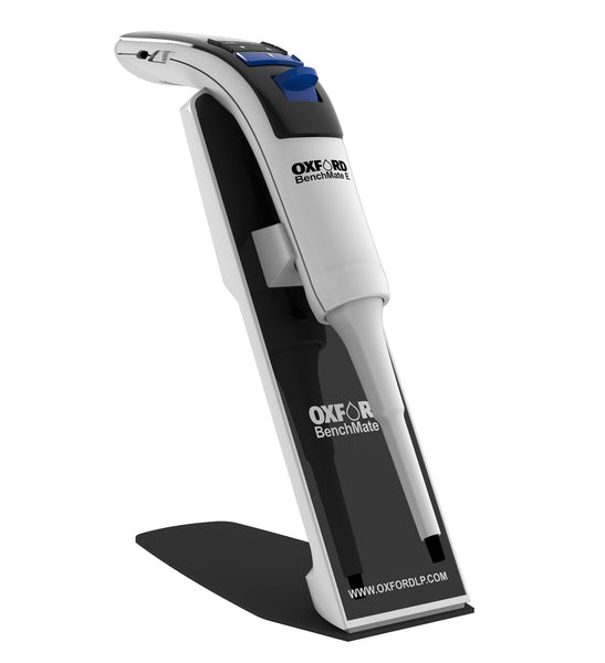 White and black single channel electronic pipette by Oxford Lab Products on a black stand.
