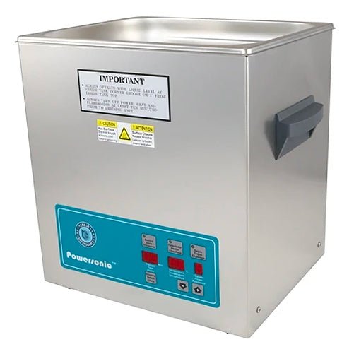 Stainless steel ultrasonic cleaner by Crest Ultrasonics with a gray handle on its side.