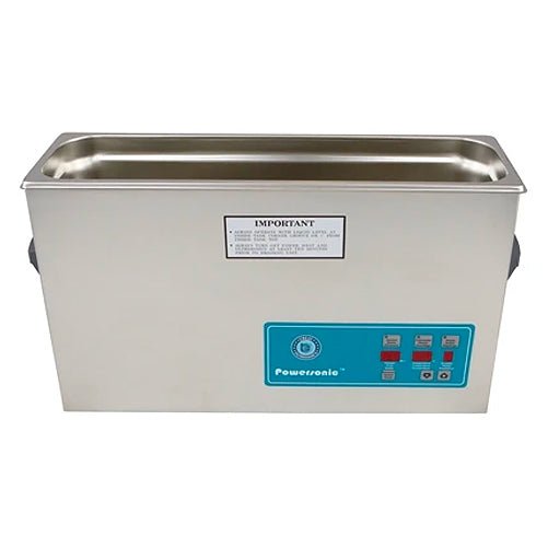 Stainless steel benchtop cleaner tank by Crest Ultrasonics with a teal control panel and warning label.