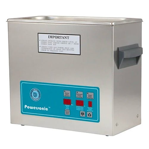 Stainless steel benchtop ultrasonic cleaner by Crest Ultrasonics with a teal control panel and a gray handle.

