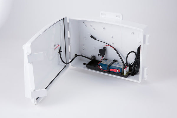 Accessory solar power kit by Davis Instruments inside a white plastic casing with wires and batteries.