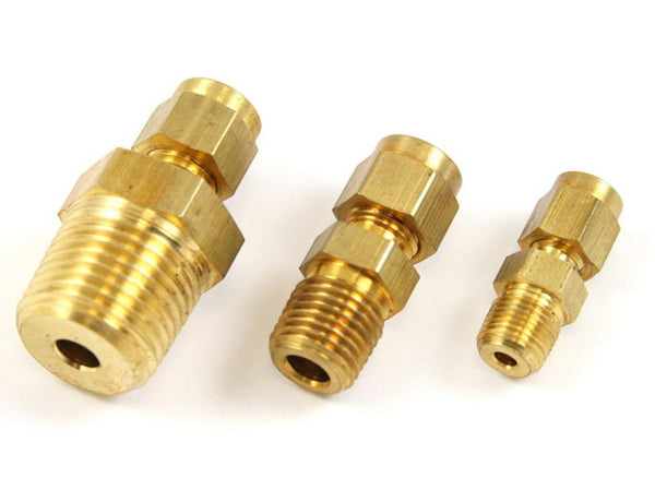 Brass thermocouple compression fittings by Pyromation in varying sizes, displaying threaded ends and hexagonal nuts.
