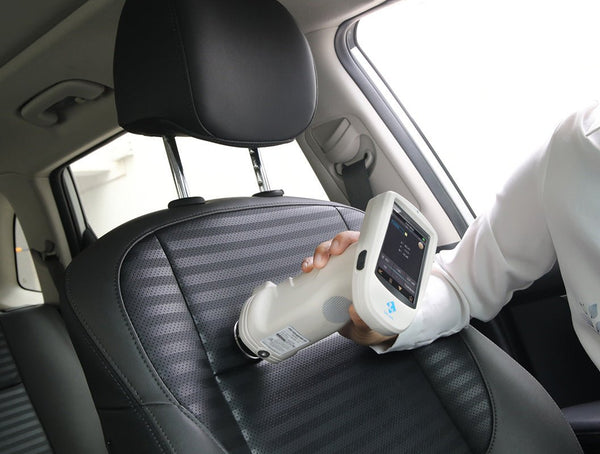 Handheld grating spectrophotometer by 3nh testing the color of a car seat.

