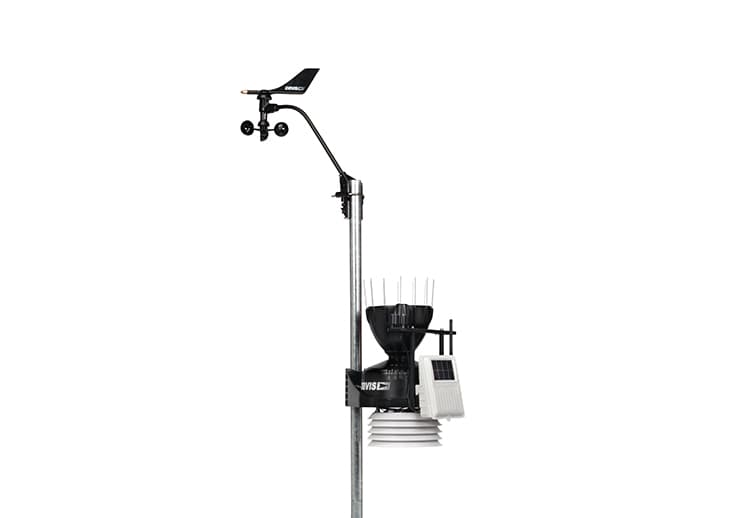 Wireless weather station by Davis Instruments, showing an anemometer and rain collector mounted on a metal pole.