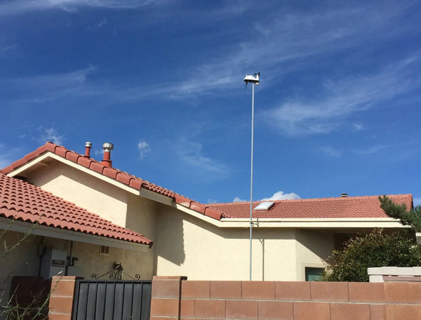 Wireless Vantage Vue weather station by Davis Instruments with sensors mounted atop a tall silver pole.

