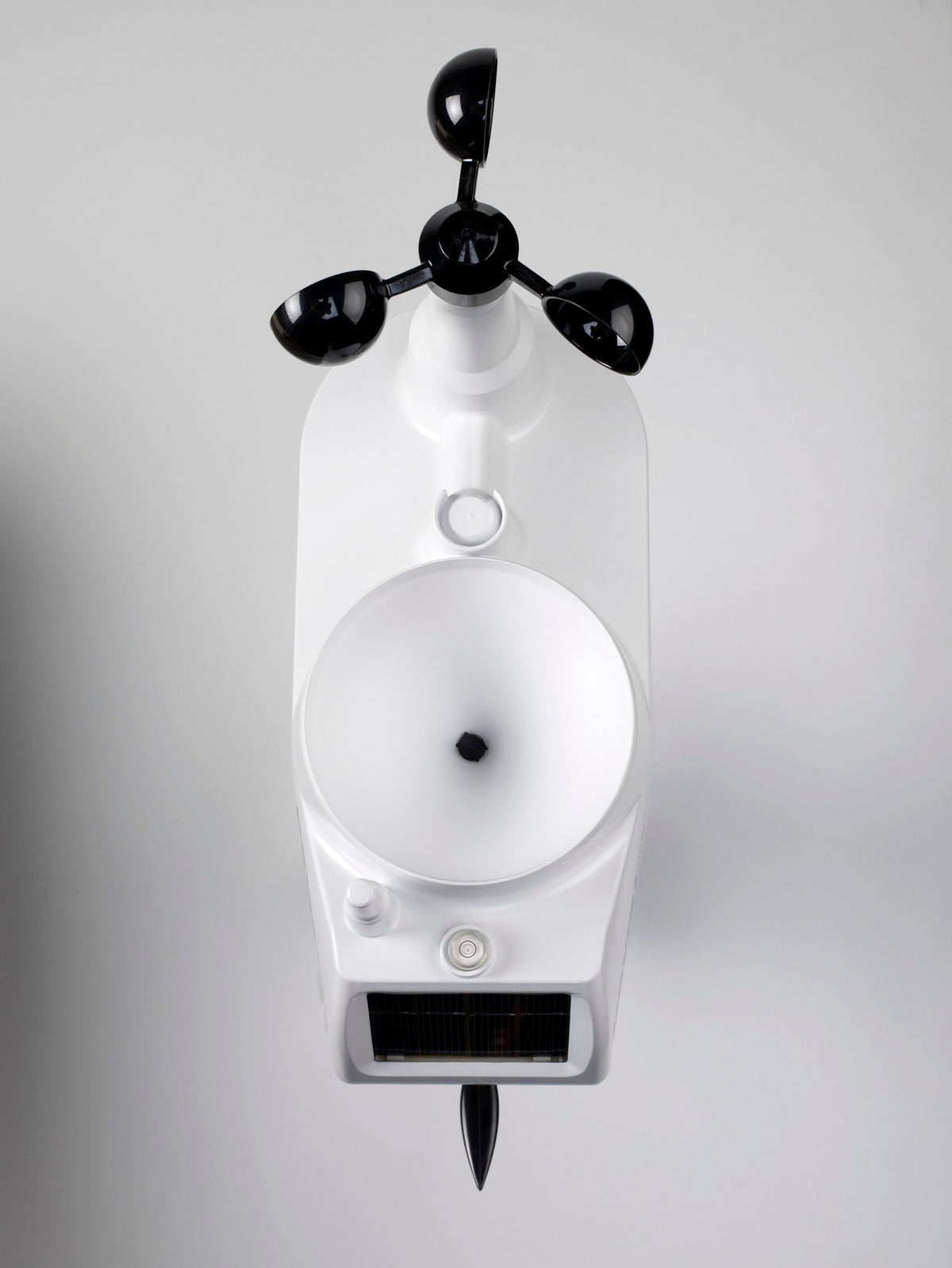 Wireless weather station by Davis Instruments with anemometer, rain collector, and solar panel against a gray background.