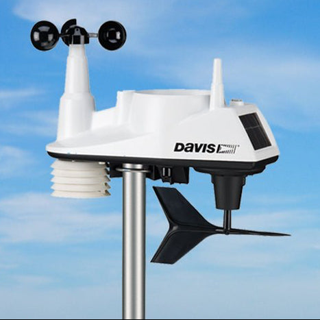 White weather station by Davis Instruments with wind speed sensor, solar panel, and rain collector.