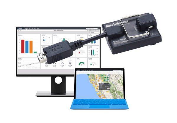 Black WeatherLink USB data logger by Davis Instruments with a USB cable connected to a monitor and laptop.