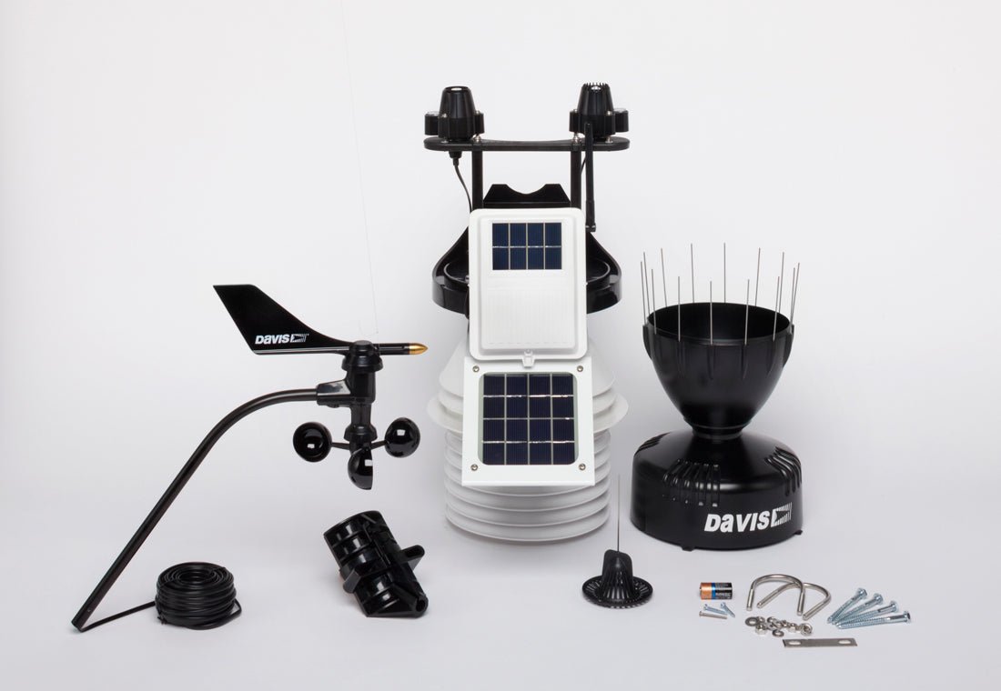 Wireless weather station with fan-aspirated radiation shield by Davis Instruments, featuring anemometer, rain collector, and solar panels.