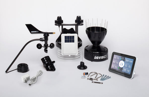 Wireless weather station by Davis Instruments with various sensors and display console against a white background.

