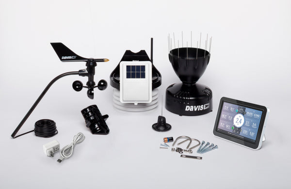 Wireless Vantage Pro2 weather station with standard radiation shield and WeatherLink console by Davis Instruments, displayed with various hardware components.
