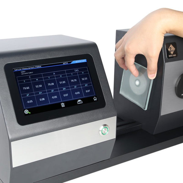 Horizontal color haze meter by 3nh with a touchscreen display and hand inserting sample material.