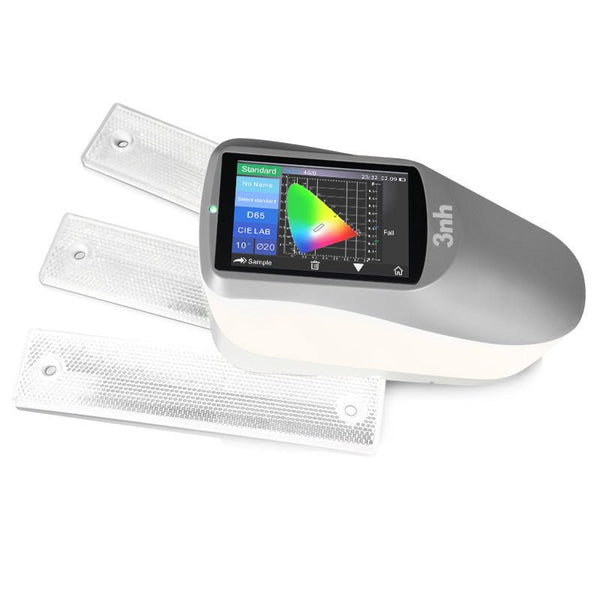 Portable spectrophotometer by 3nh displaying a color chart on its screen, next to three reflective sample panels.

