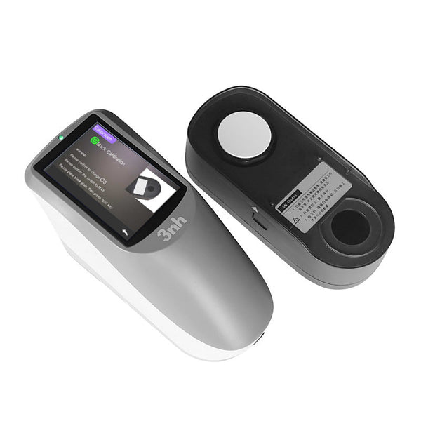 Gray portable spectrophotometer by 3nh with a calibration screen displayed and a black calibration component.