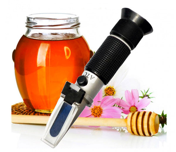 Honey refractometer, 58 to 90% with ATC, by Sper Scientific, with a jar of honey and a honey dipper.
